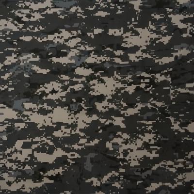 A camouflage fabric features a pixelated pattern in shades of gray and black with patches of beige creating a textured appearance ideal for blending into various environments.