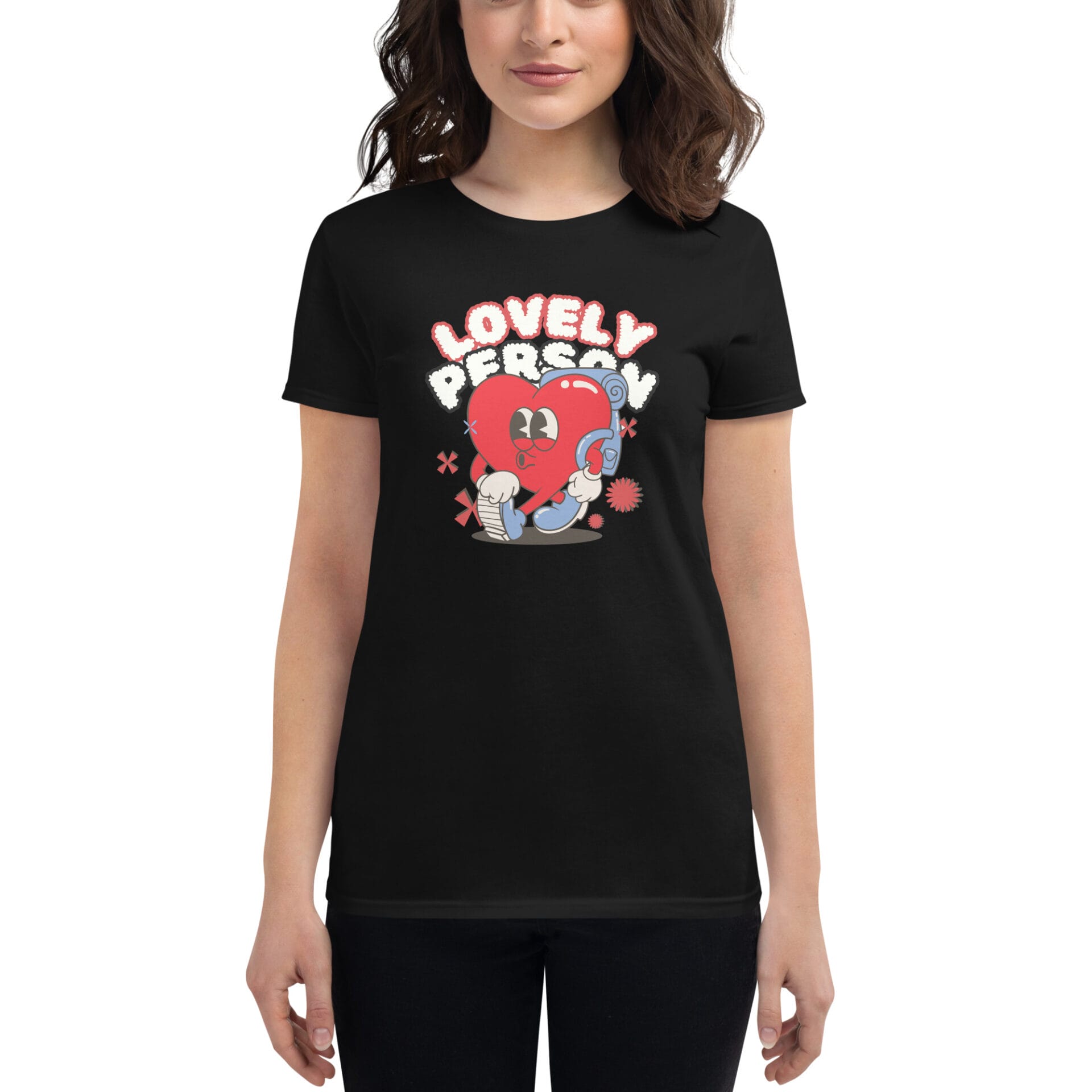 A woman is wearing a black t-shirt featuring a colorful heart character holding a microphone with the text "LOVELY PERSON" above it while she smiles at the camera.