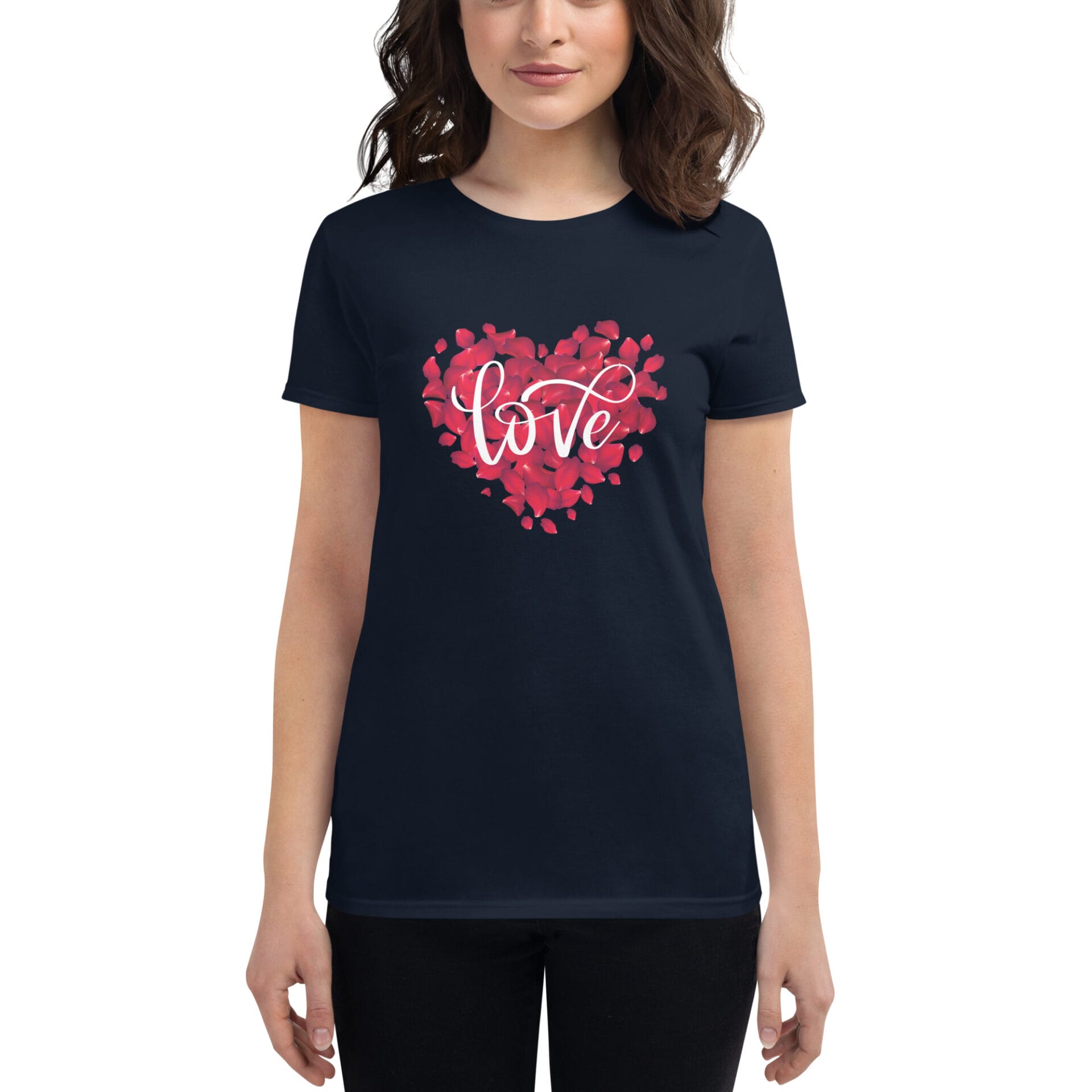 A dark navy t-shirt features a heart shape made of red rose petals with the word love scripted in white at the center the wearer stands casually with a neutral expression.